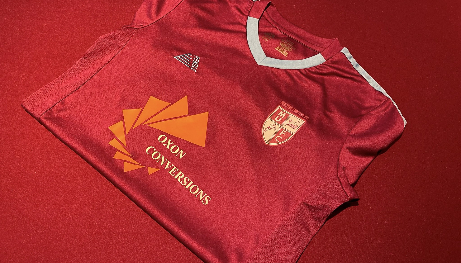 Red football shirt with Oxon Conversions logo